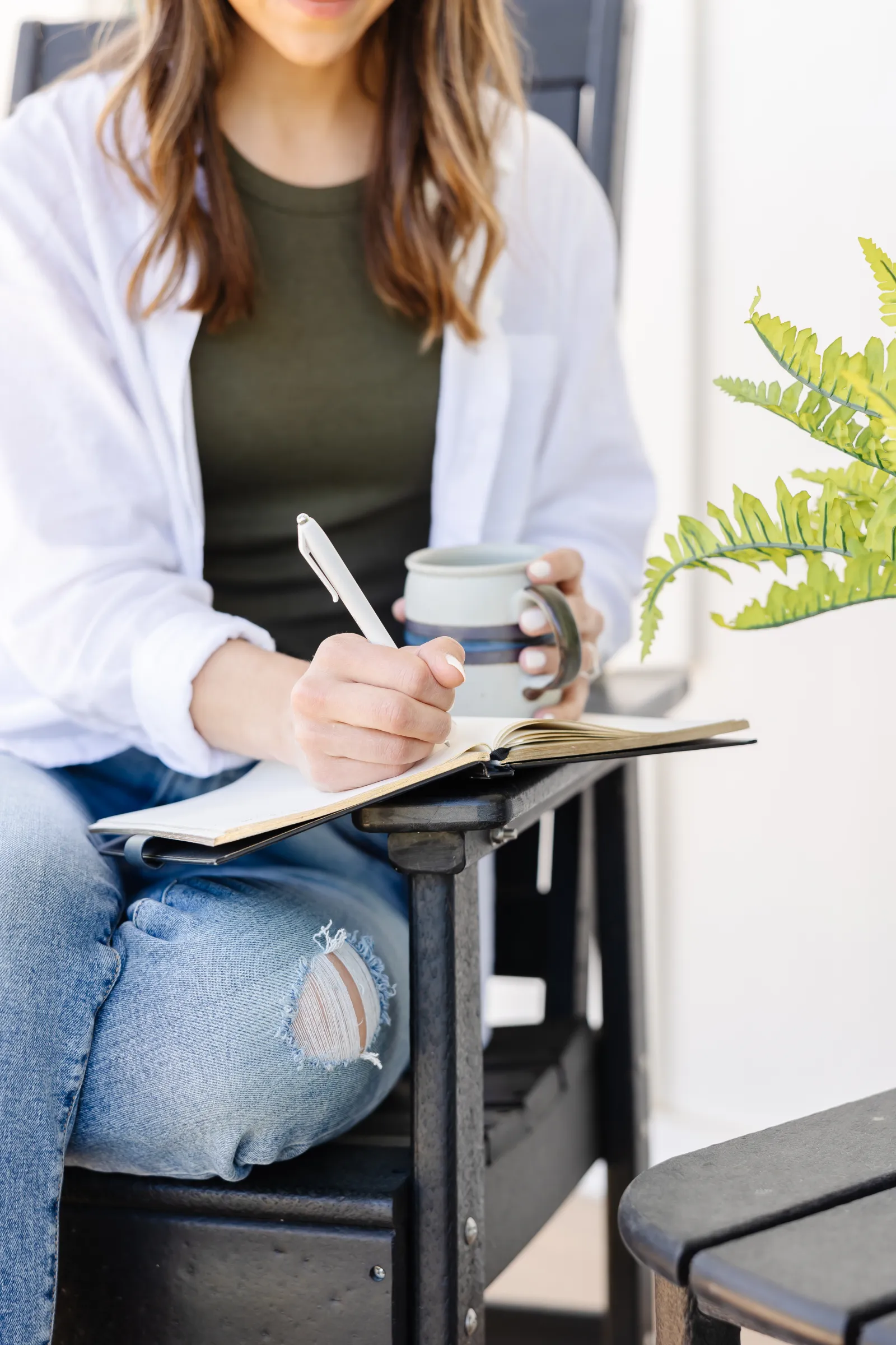 Alicia journaling with coffee, warm natural light